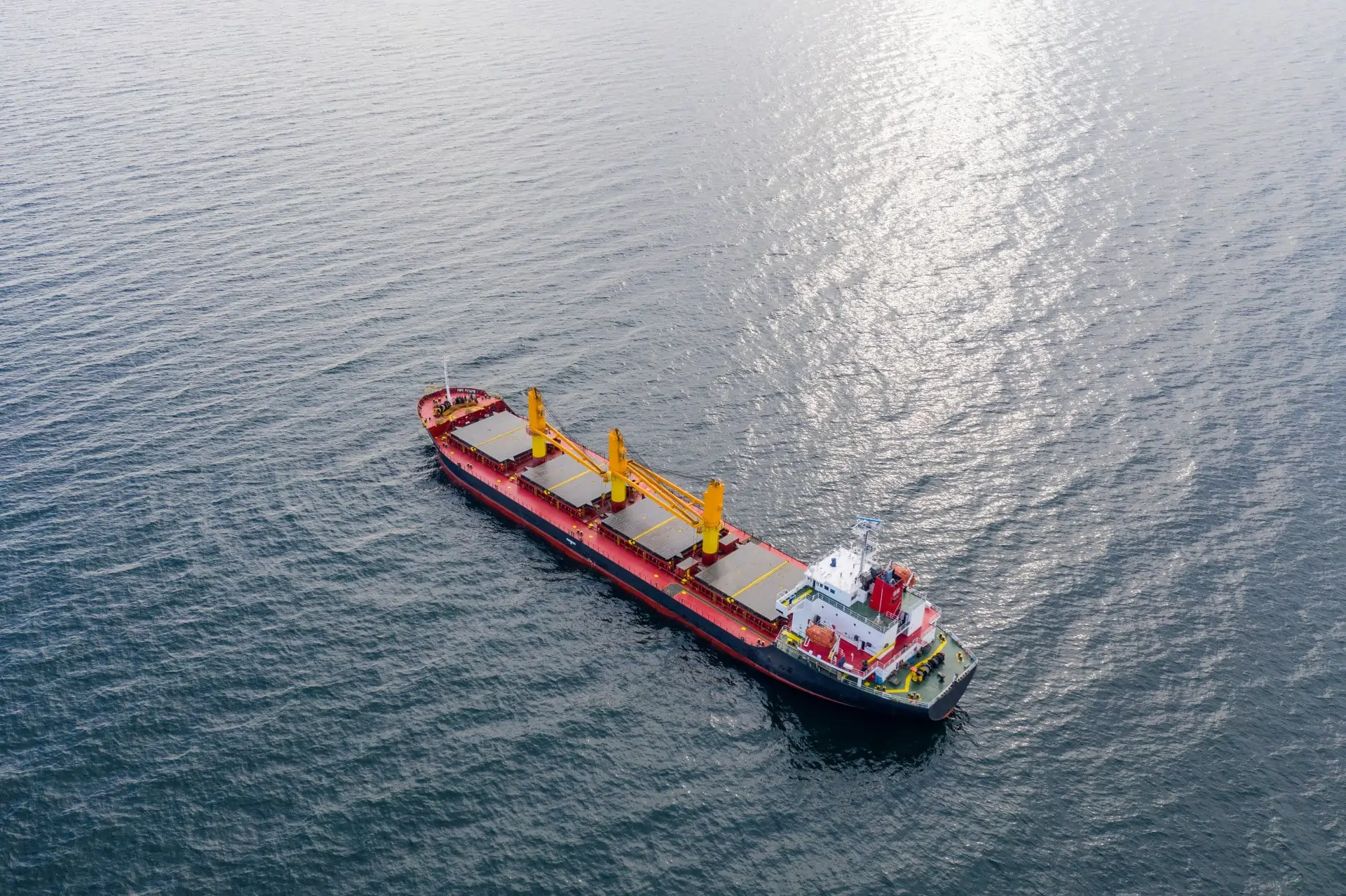 Aerial top view of cargo ship vessel import export sailing.
